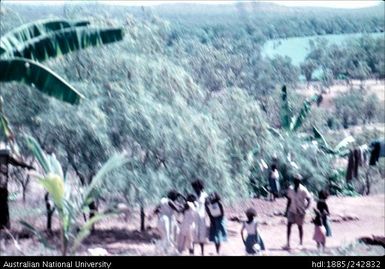 Indigenous people walking along a path
