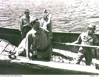 THE SOLOMON ISLANDS, 1945-08-20. JAPANESE PERSONNEL MANNING A BARGE ALONGSIDE HMAS LITHGOW OFF MOILA POINT. THE BARGE HAD DELIVERED TWO JAPANESE OFFICERS FOR ARRANGEMENTS TO BE MADE FOR A SURRENDER ..