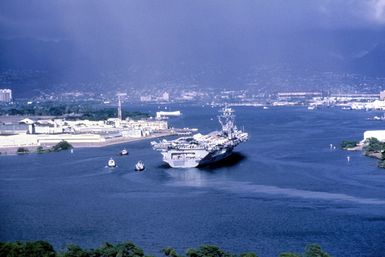 Aerial starboard quarter view of the nuclear-powered guided missile cruiser USS CARL VINSON (CVN 70) entering port