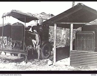 JACQUINOT BAY, NEW BRITAIN, 1945-11-20. THE TWO MOBILE ELECTRICITY GENERATING SETS WHICH SUPPLY THE POWER FOR THE OPERATION OF THE AUSTRALIAN ARMY AMENITIES SERVICE BROADCASTING STATION 9AE