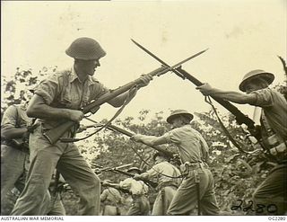 TOROKINA, BOUGAINVILLE ISLAND, SOLOMON ISLANDS. C. 1945-02-23. RAAF PERSONNEL PRACTISING BAYONET FIGHTING IN FULL KIT DURING TRAINING IN THE TOROKINA AREA