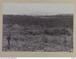 WEWAK POINT, NEW GUINEA, 1945-05-17. JAPANESE GUNS ON THE WIRUI MISSION AREA, NOW OCCUPIED BY 2/2 FIELD REGIMENT ROYAL AUSTRALIAN ARMY TROOPS, MUSCHU ISLAND AND KAIRIRU ISLAND CAN BE SEEN IN THE ..