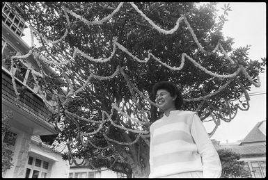 Penny Aoina standing under a Christmas tree on Pipitea Street, Wellington