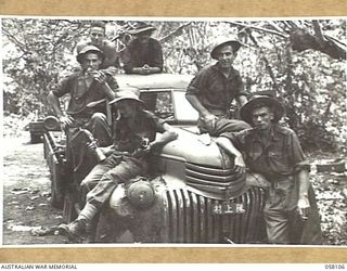 FINSCHHAFEN, NEW GUINEA, 1943-10-02. SIGNALLERS OF THE 9TH AUSTRALIAN DIVISION ON A CAPTURED JAPANESE TRUCK. NOTE THE NUMBER PLATE ON THE FRONT OF THE VEHICLE