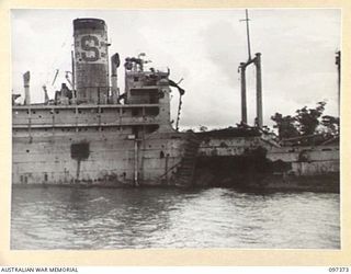 MOILA POINT, BOUGAINVILLE. 1945-09-28. THE HITATI MARU, A JAPANESE MERCHANT SHIP WHICH RAN ASHORE NEAR KANGU HILL AFTER A SUCCESSFUL ATTACK BY ALLIED AIRCRAFT