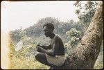 Man sitting on tree base