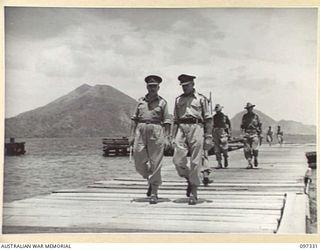 RABAUL, NEW BRITAIN. 1945-09-27. LIEUTENANT GENERAL J. NORTHCOTT, CHIEF OF GENERAL STAFF (1), ACCOMPANIED BY MAJOR GENERAL K.W. EATHER, GENERAL OFFICER COMMANDING 11 DIVISION (2), AND STAFF ..