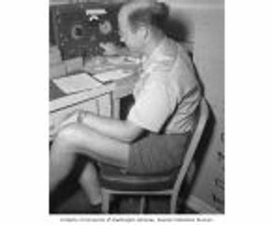 J. P. Pflueger working with scientific instruments, Bikini Atoll, summer 1947