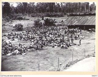 TOROKINA, BOUGAINVILLE. 1945-09-23. GENERAL VIEW FROM THE WATCHING TOWER AT THE CHOP CHOP TRAIL COMPOUND SHOWING JAPANESE NAVAL TROOPS LINED UP IN THE SEARCHING COMPOUND. THE JAPANESE TROOPS HAVE ..