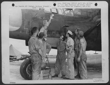 Lt. D.F. Haberman Points Proudly To His First Jap 'Score Flag' On The Nose Of His Northrop P-61 'Black Widow' As Far As It Is Known This Is The First P-61 To Shoot Down An Enemy Plane. Saipan, Marianas Islands, 1 July 1944. (U.S. Air Force Number 63584AC)