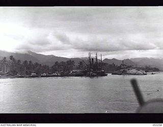 MILNE BAY, NEW GUINEA. 1943-06-29. CHINESE FREIGHTER "ASHUN" LYING ON HER SIDE AFTER BEING SUNK BY JAPANESE WARSHIPS DURING THE BATTLE FOR MILNE BAY