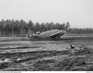 MILNE BAY, PAPUA. C. 1942-09/10. A HUDSON BOMBER AIRCRAFT OF NO. 6 SQUADRON RAAF TAXIING ON THE MUDDY GURNEY AIRSTRIP