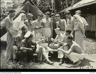 MILNE BAY, PAPUA. C. 1944-02. RAAF NURSING SISTERS YOUNG (LEFT) AND PERGER WATCH A GROUP OF RAAF PATIENTS PLAYING CARDS AT AN OUTSIDE TABLE AT 2 MEDICAL CLEARING STATION