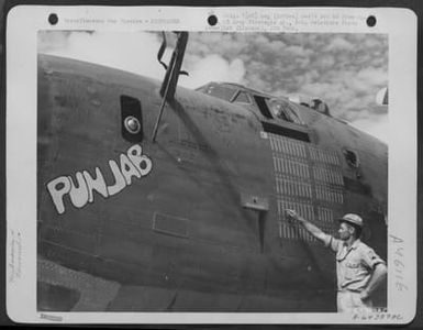 Crew Chief, M/Sgt. Melvin L. Hotz Of Olin, Iowa, Counts The Bombs Which Have Been Painted On The Nose Of The Consolidated B-24 Liberator 'Punjab'. Saipan, Marianas Islands, 1944. (U.S. Air Force Number A64389AC)