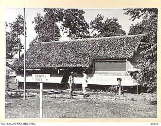 LAE AREA, NEW GUINEA. 1945-05-25. EXTERIOR VIEW OF THE DENTAL POST, 54 DENTAL UNIT, TAKEN FROM THE SURGERY END OF THE BUILDING. DR. WARNER, SCIENTIFIC LIAISON SECTION ATTACHED FIRST ARMY, WHO IS ..