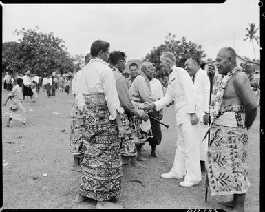 The High Commissioner Guy Powles greeting a group of Samoan men in Apia - Photograph taken by Mr W Walker