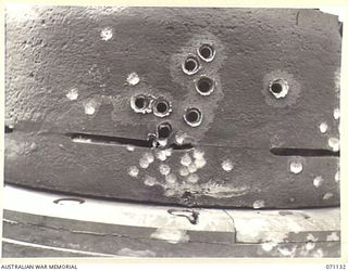 GUSIKA, NEW GUINEA. 1944-03-15. THE EFFECTS OF A .55" TANK ATTACK RIFLE FIRED FROM A RANGE OF 75 YARDS AT THIS CUPOLA, WHICH HAS BEEN FITTED TO THE BODY OF A MATILDA TANK BY MEMBERS OF THE 1ST TANK ..