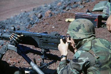 A member of Weapons Company, 1ST Battlion, 3rd Marines, fires an M-2.50-caliber machine gun during a Marine Corps combat readiness evaluation