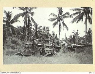 HANSA BAY, NEW GUINEA. 1944-06-19. NX155299 SAPPER L.H. KENT (1) AND QX48006 SAPPER D. MCSTAY (2) BOTH OF HEADQUARTERS, 5TH DIVISION, EXAMINING A JAPANESE TWIN ENGINED BOMBER AND AN AIRCRAFT ..