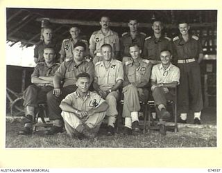 MILILAT, NEW GUINEA. 1944-07-27. OFFICERS OF HEADQUARTERS, 5TH DIVISION OUTSIDE THEIR MESS. IDENTIFIED PERSONNEL ARE:- 139819 FLYING OFFICER R.A. SCUTT, RAAF (1); VX108010 CAPTAIN R.D. DOUGLAS (2); ..