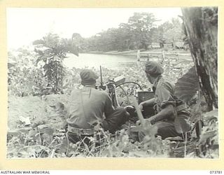 KARKAR ISLAND, NEW GUINEA. 1944-06-02. MEMBERS OF THE 37/52ND INFANTRY BATTALION MANNING A VICKERS MACHINE GUN DEFENCE POSITION AT BISON BAY. IDENTIFIED PERSONNEL ARE:- VX118724 PRIVATE A.A. SHAW ..