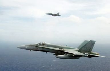 Two Royal Canadian Navy CF-18C Hornet aircraft fly over the Pacific Ocean off the coast near Pearl Harbor, Hawaii (HI) in celebration of Canada Day for the Rim of the Pacific (RIMPAC) 2006 Exercise, the world's largest biennial maritime exercise