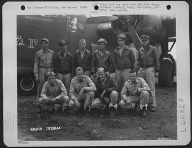 1st Lt. D. White and crew of the 65th Bomb Squadron, 43rd Bomb Group, poses by the Consolidated B-24 "Stugotts Ist" at Dobodura Airstrip, Papua, New Guinea. 12 February 1944. (U.S. Air Force Number 72367AC)