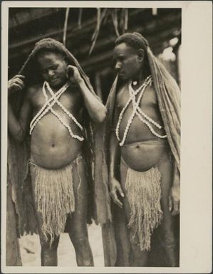 Two Kukukuku men wearing  bark tapa cloth cloaks, Salamaua, New Guinea, 1933 / Sarah Chinnery