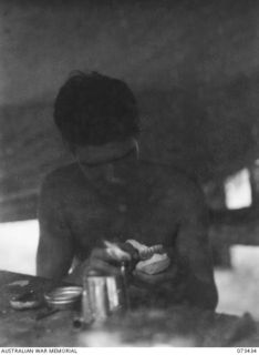 ALEXISHAFEN, NEW GUINEA. 1944-05-22. VX85609 CORPORAL R.J. MERTON (1), SETTING ARTIFICIAL TEETH IN THE TENT WORKSHOP AT C SECTION. 2/5TH DENTAL UNIT