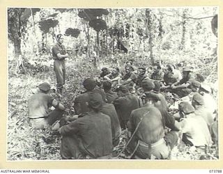 KARKAR ISLAND, NEW GUINEA. 1944-06-02. MEMBERS OF THE 37/52ND INFANTRY BATTALION PARTICIPATING IN AN OPEN AIR CHURCH OF ENGLAND SERVICE AT BISON BAY. IDENTIFIED PERSONNEL ARE:- QX48266 CHAPLAIN ..