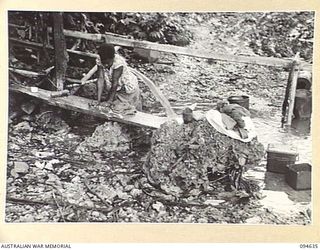 SIPILANGAN, NEW BRITAIN, 1945-07-29. A YOUNG NATIVE WOMAN DOING THE WASHING AT A NEARBY CREEK AT THE AUSTRALIAN NEW GUINEA ADMINISTRATIVE UNIT DISTRICT SERVICES TOL REFUGEE CAMP. THE CAMP, SITUATED ..