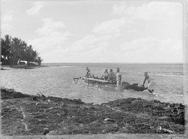 [Group of men with canoe]