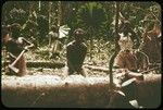 Carving a canoe with axes