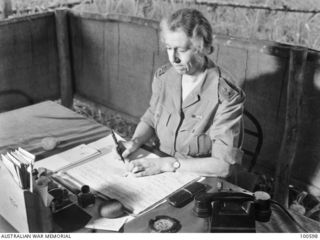 Lae, New Guinea. 1944-08-02. Portrait of Matron E. F. Johns, Australian Army Nursing Service (AANS), 2/7th Australian General Hospital, sitting at her desk