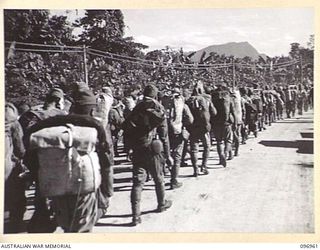 TOROKINA, BOUGAINVILLE. 1945-09-23. JAPANESE NAVAL TROOPS CARRYING PERSONAL GEAR ON A 10-MILE MARCH FROM THE BUKA AREA, ESCORTED BY TROOPS OF 27 INFANTRY BATTALION. THE JAPANESE, WHO ARE MARCHING ..