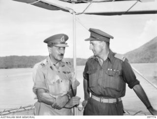 TOBOI WHARF, RABAUL, NEW BRITAIN. 1945-10-05. MAJOR GENERAL B.M. MORRIS, COMMANDER AUSTRALIAN NEW GUINEA ADMINISTRATIVE UNIT (1) AND MAJOR BATES (2) ABOARD THE LAURABADA. MAJOR GENERAL MORRIS IS ..