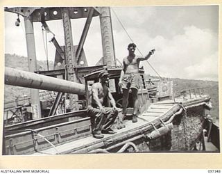 RABAUL, NEW BRITAIN. 1945-09-30. W.R. BERWICK, SALVAGE ENGINEER (1), AND J. RUSHTON, SHIPWRIGHT (2), ON ONE OF THE JAPANESE SPEED LAUNCHES ON THE FORWARD DECK OF THE JAPANESE TANKER NO. 5301. THE ..