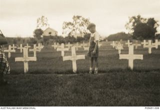 Julian Collins at the grave of his father, 400871 Flight Sergeant (Flt Sgt) Austin James Collins, air gunner, in Port Moresby, Papua New Guinea. Flt Sgt Collins served in Malaya with the RAF and ..