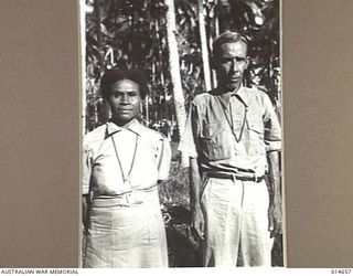 MILNE BAY, PAPUA. 1943-04-14. DECORATIONS FOR FUZZY-WUZZIES. NEARLY THREE THOUSAND NATIVES HELD A FEAST AT MILNE BAY AFTER SIX OF THEIR MEMBERS RECEIVED MEDALS FOR LOYAL SERVICE DURING THE BATTLE ..