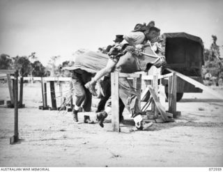 PORT MORESBY, NEW GUINEA. 1944-04-23. NX68063 PRIVATE L.G. HALLORAN (1), ENCOUNTERING DIFFICULTIES WITH HIS MOUNT "PATCHES" AT THE HURDLES DURING A NOVELTY EVENT IN THE 2/101ST GENERAL TRANSPORT ..