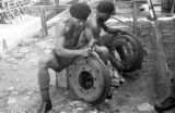 Malaysia, Republic of Fiji Military Forces soldiers fixing tire rims