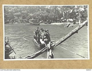 GOALING RIVER, NEW GUINEA. 1944-01-21. A SECTION OF AUSTRALIAN INFANTRY CROSSING THE RIVER IN A JAPANESE FERRY WHICH WAS LEFT BEHIND BY THE RETREATING ENEMY