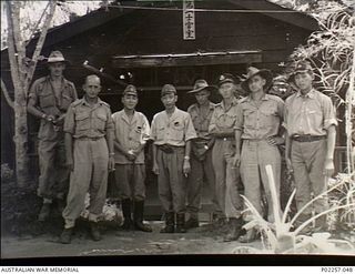 Lesson Point, Rabaul, New Britain, 1945-10. Informal outdoors group portrait of Japanese servicemen with members of a RAAF Equipment Recovery Party after the Japanese surrender. The men are (left ..