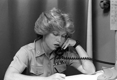 LT Billie Elizabeth Crawford uses the telephone to accomplish some of her work. She is a Navy planning officer and the first woman both on board the USS JASON (AR-8) and in Pearl Harbor to become surface warfare qualified. She is now equally qualified to be officer-of-the-deck (OOD) underway and command duty officer (CDO) in port