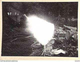 BARGES HILL, CENTRAL BOUGAINVILLE, 1945-06-26. A TROOP, 10 BATTERY, 4 FIELD REGIMENT IS CONTINUOUSLY HARRASSING THE JAPANESE WITH FIRE AND GIVING THEM NO REST DAY OR NIGHT. SHOWN, LAYING HARASSING ..