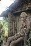 Portrait of man sitting in front of a building