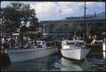 Papeete waterfront, small boats, bus, Bloc Donald building