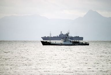 A port beam view of a Soviet Moma class intelligence collection ship escorting the amphibious assault ship USS SAIPAN (LHA-2) off the coast of Norway near the Vjest Fjord during NATO exercised Northern Wedding '86