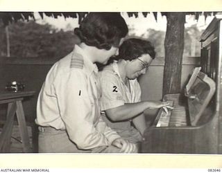 LAE AREA, NEW GUINEA. 1944-11-06. MISS D. MERRY, YOUNG WOMEN'S CHRISTIAN ASSOCIATION WELFARE OFFICER (1), PROVIDING FREE LESSONS AT THE AUSTRALIAN ARMY MEDICAL WOMEN'S SERVICE REST HUT, 2/7 GENERAL ..