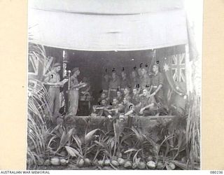 ALEXISHAFEN, NEW GUINEA. 1944-07. THE CHOIR ON STAGE DURING A CONCERT HELD AT HEADQUARTERS 8TH INFANTRY BRIGADE, NORTH ALEXISHAFEN. FOR IDENTIFICATION OF 17 PERSONNEL SEE PROVISIONAL CAPTION